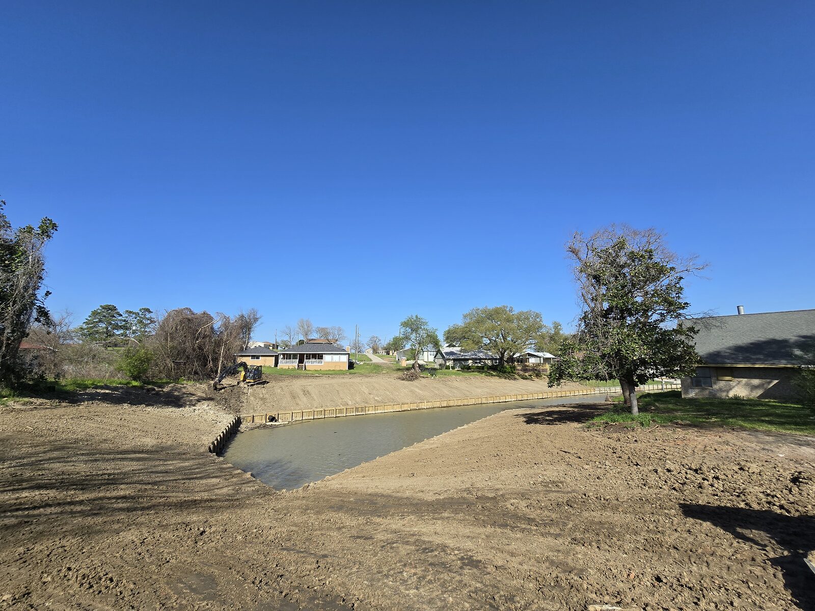 Completed continuous shoreline bulkhead and regraded waterfront along a Texas lake subdivision