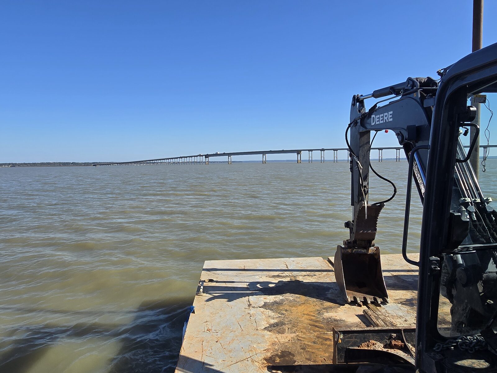 Sectional dredge barge working a marina basin near the docks on a Texas lake