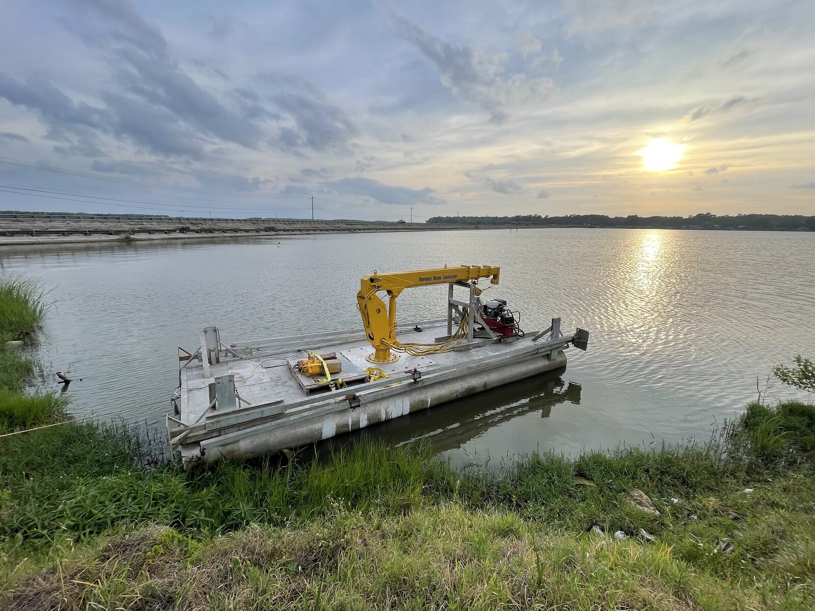 Precision dredge barge at sunset on Lake Livingston