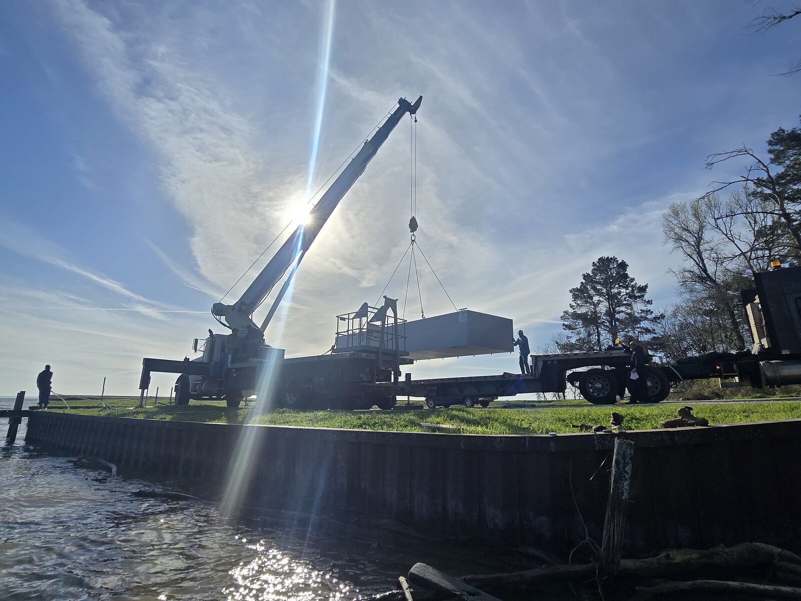 Marine crane and barge lift on a commercial waterfront project