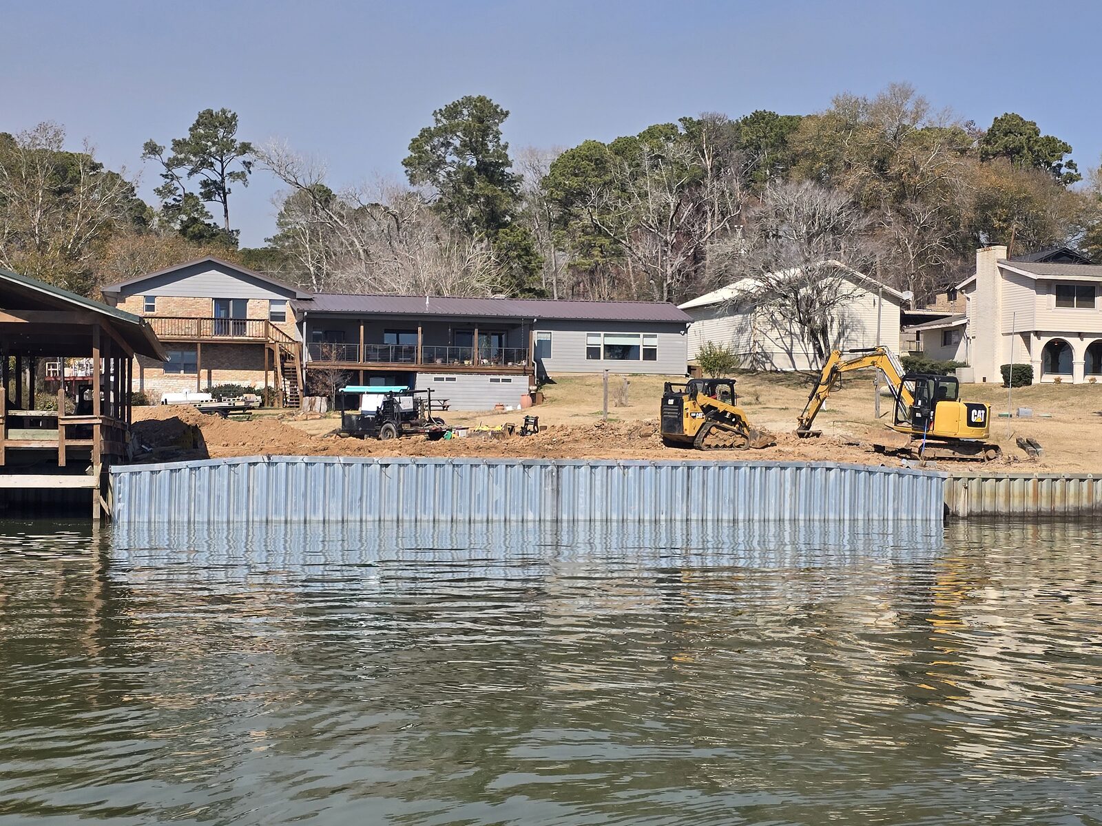 Dredging restoring canal access along a waterfront subdivision